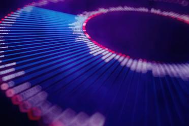 An abstract representation of genome data visualisation, showing lines radiating out from an inner circle in hues of blue, purple and pink.